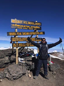 Sam Pasupalak at the peak of Mount Kilimanjaro