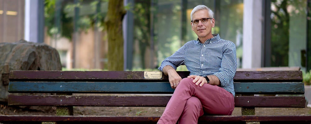 photo of Professor Daniel Vogel on bench in Waterloo rock garden