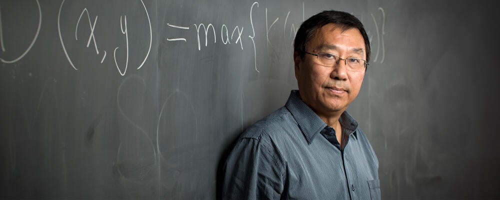 photo of University Professor Ming Li by blackboard