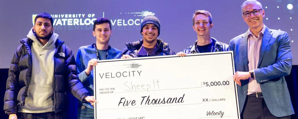 Photo of the team holding a $5,000 cheque