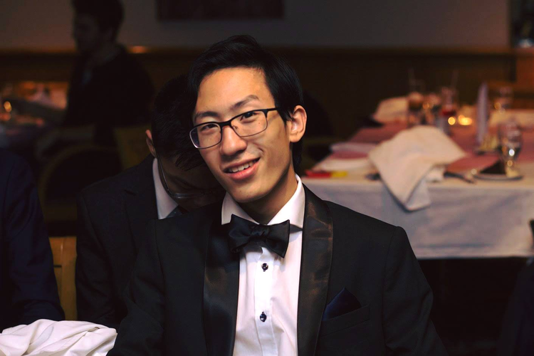 photo of Jeff in a suit &amp; bow tie sitting down posing at the Math Ball