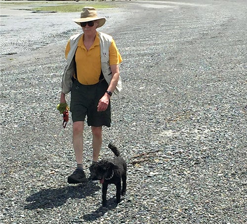 John Beatty and his poodle Sparky walking on the beach at Gabriola Island