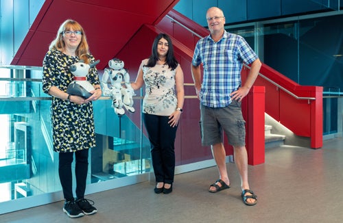 photo of Kerstin Dautenhahn, Moojan Ghafurian and Jesse Hoey with social robots