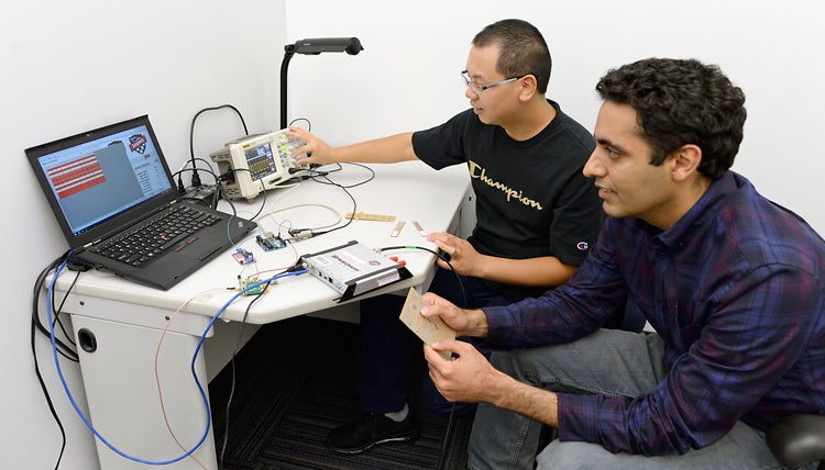 Omid Abari and Ju Wang demonstrate the wireless keypad clicker they invented