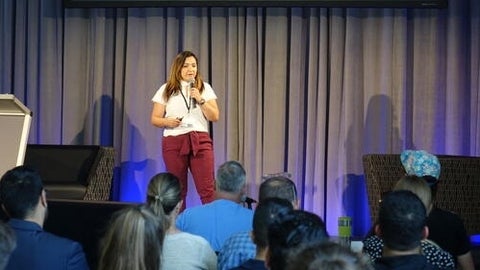 Photo of Glaucia Melo dos Santos presenting in front of a crowd at the Concept 5K start-up challenge
