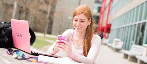 Female student on computer and phone