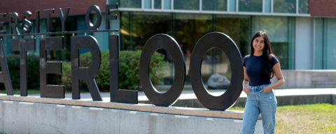 Nikhita Joshi posing in front of the University of Waterloo sign (outdoor pic)