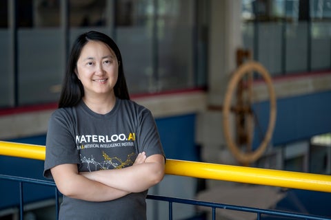 Professor Xi He posing inside DC. She is wearing a Waterloo AI t-shirt