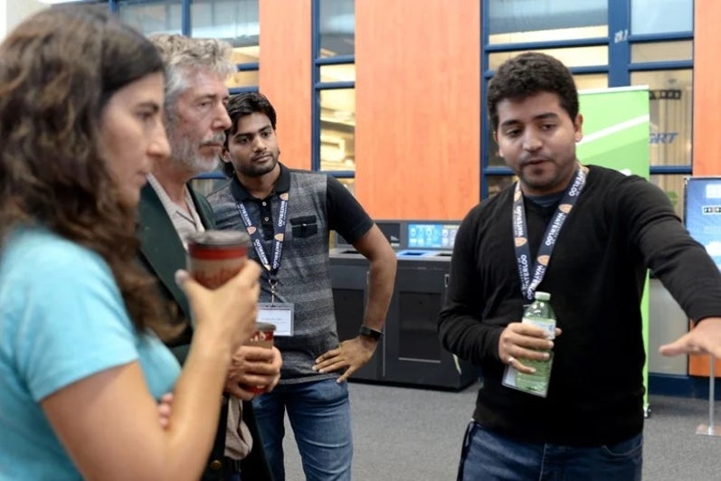 Amine Mhedhbi (R) and Siddhartha Sahu (centre) present their poster
