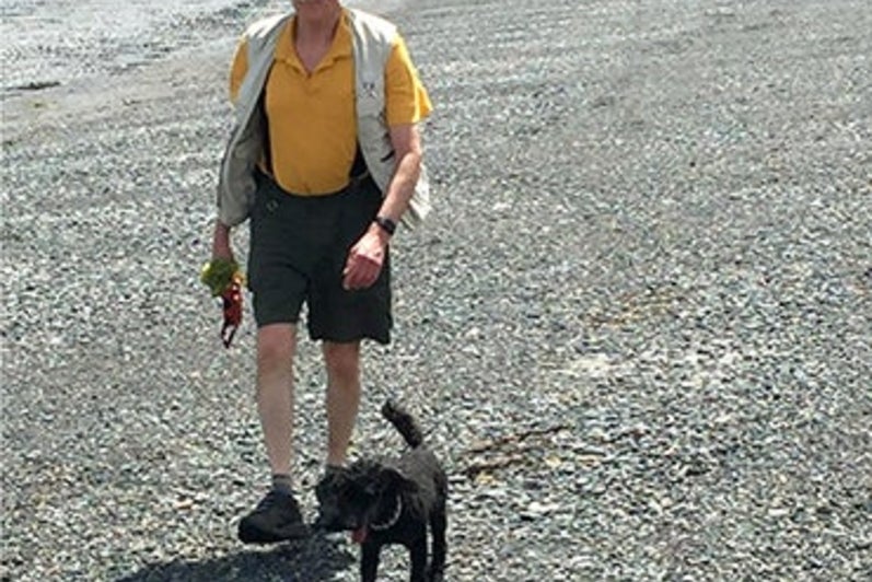 John Beatty and his younger poodle Sparky walking on the beach at Gabriola Island