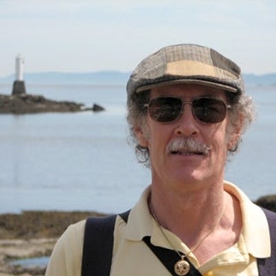John Beatty and his younger poodle Sparky walking on the beach at Sandwell Provincial Park on Gabriola Island