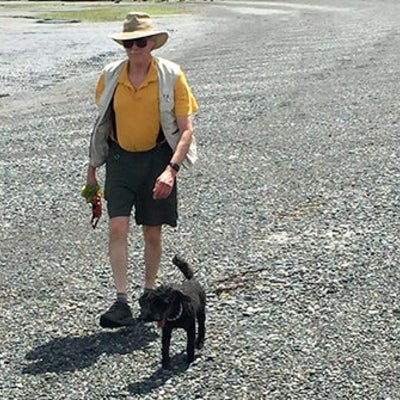 John Beatty and his younger poodle Sparky walking on the beach at Gabriola Island