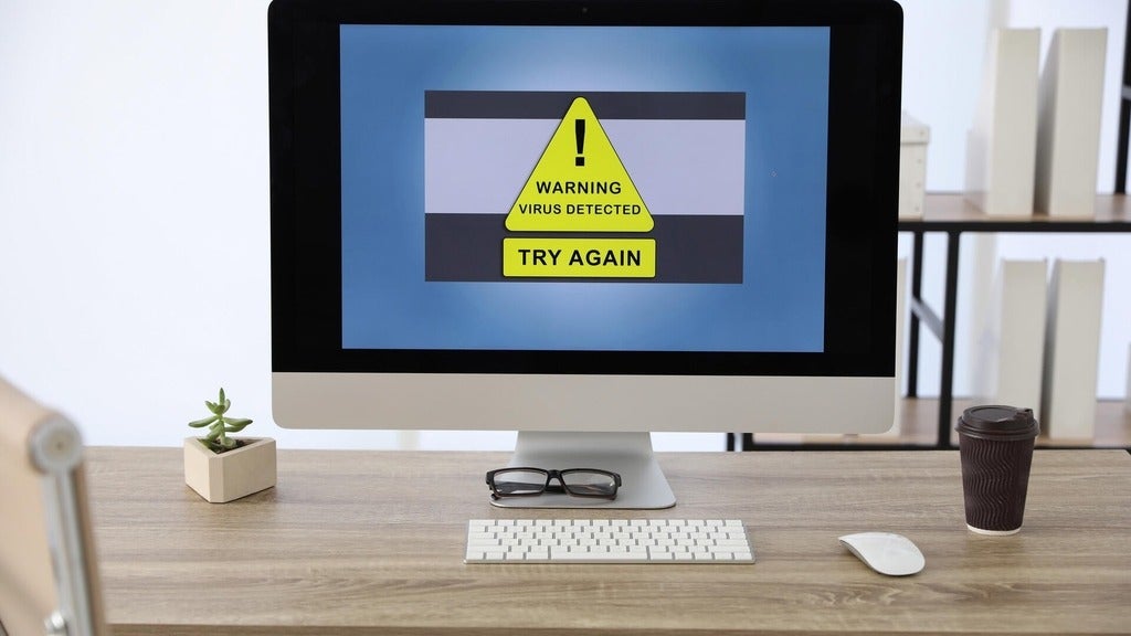 desktop computer with virus detection depicted on screen