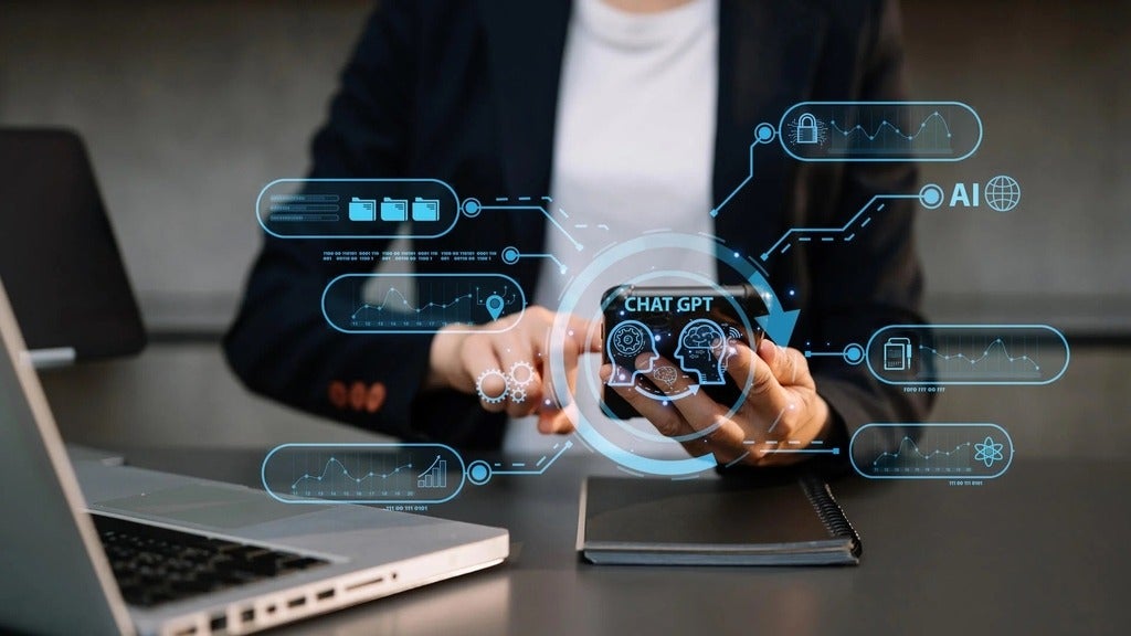 stock photo of someone wearing a blazer scrolling through the phone. Blue graphics (chatgpt or a security lock) overlaying