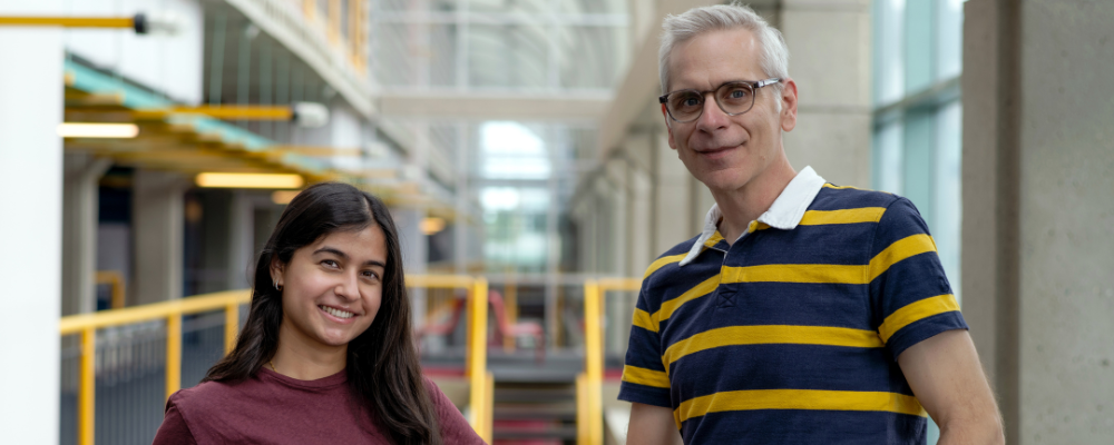 photo of Nikhita (red shirt) and Prof Vogel (black and yellow stripe shirt) posing in DC