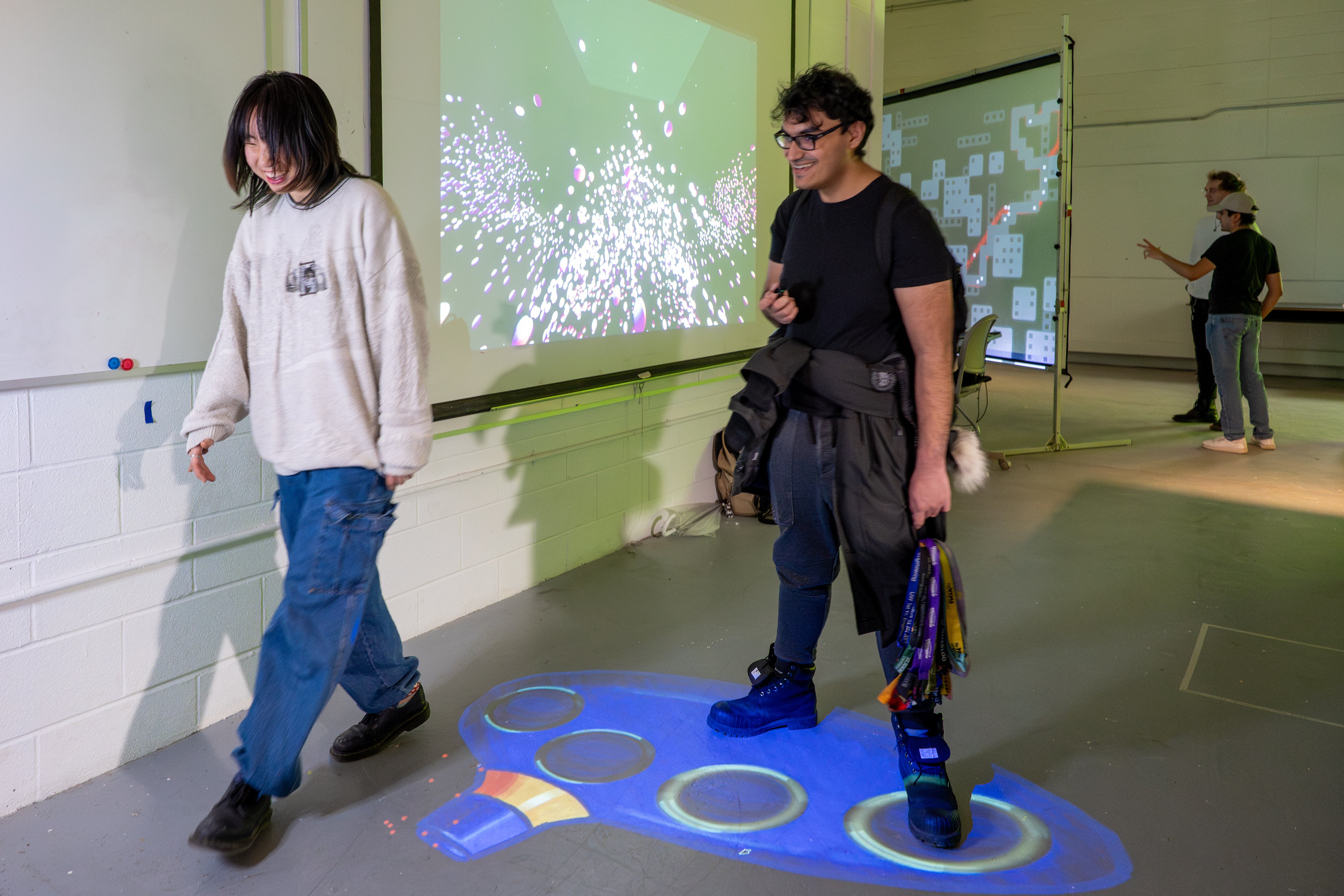 A man standing hip-distance apart on the "Floor Carina" projection, which shows a blue-coloured instrument with holes. The colouring and shape kinda looks like the Genie's bottle from Aladdin.